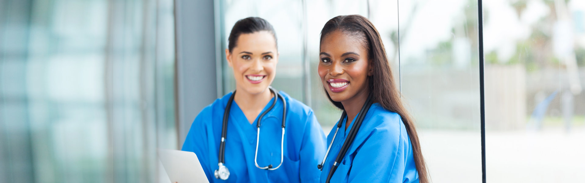 two female nurses smiling