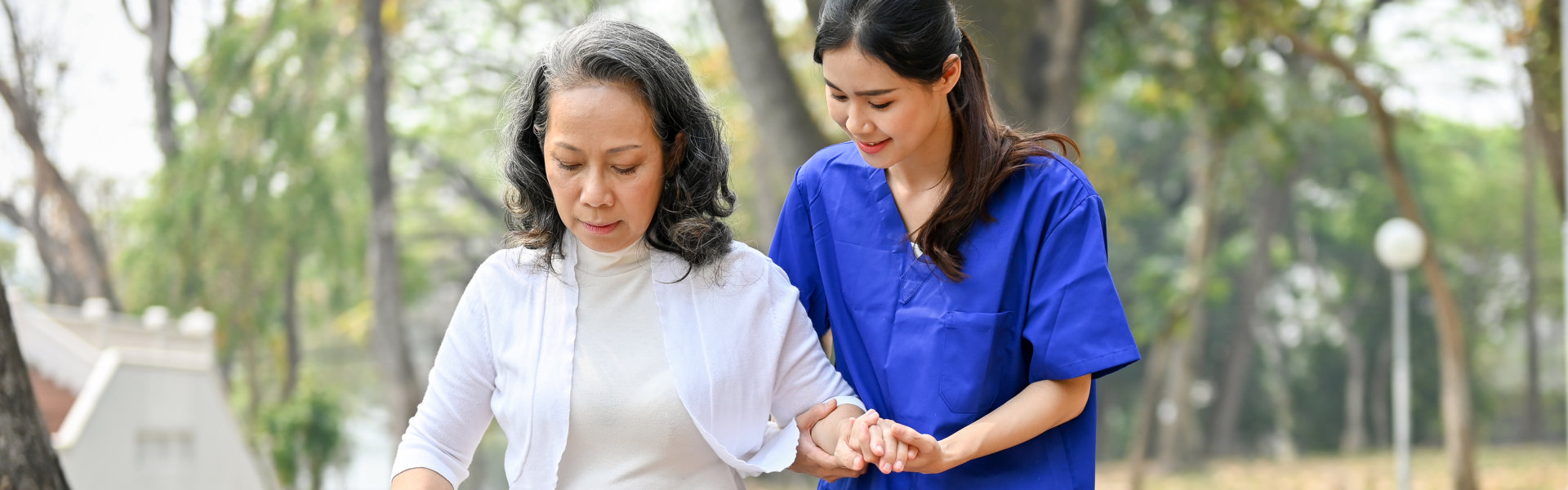 nurse guiding her patient in walking